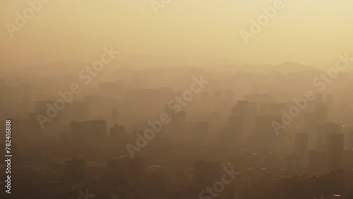 Drone aerial view of city skyline with skyscrapers in the mist or smog.