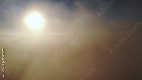 Beautiful cloudscape. Flying out of the clouds during the sunrise.