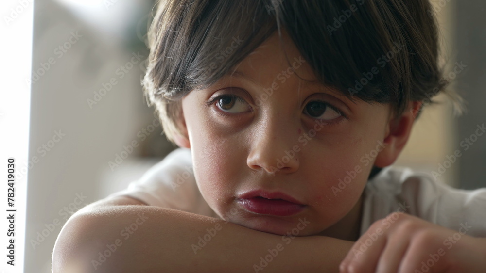 One thoughtful pensive young 5 year old bout in deep mental reflection. Introspective male caucasian kid daydreaming One thoughtful pensive young 5 year old bout in deep mental reflection. Introspective male caucasian kid daydreaming