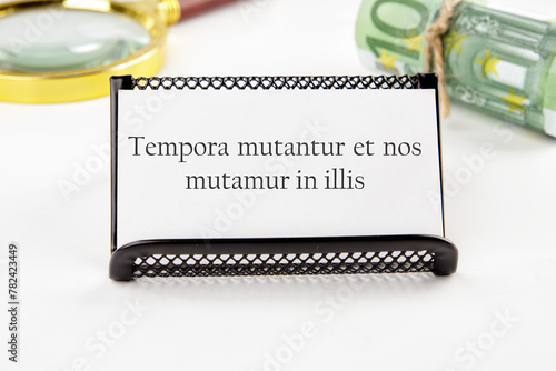 Tempora mutantur et nos mutamur in illis Translated from Latin, it means Times are changing, and we are changing with them. on a white business card photo