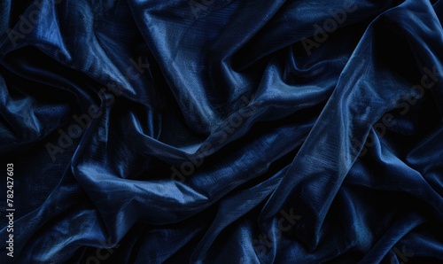 closeup view of background draped with sumptuous velvet fabric in luxurious navy blue, abstract background