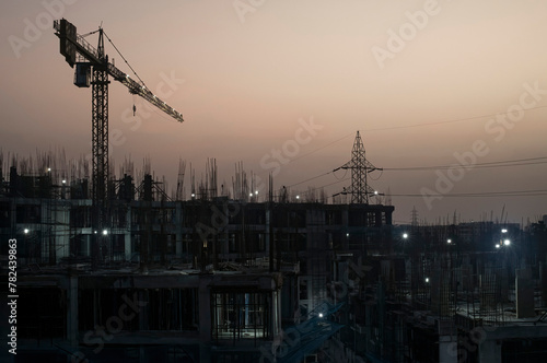 Sunrise at a construction zone with cranes in the foreground in Chennai India
