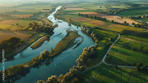 Obraz na płótnie Aerial view of European classical styled with river and cultivated agricultural farming land shot from the air w salonie