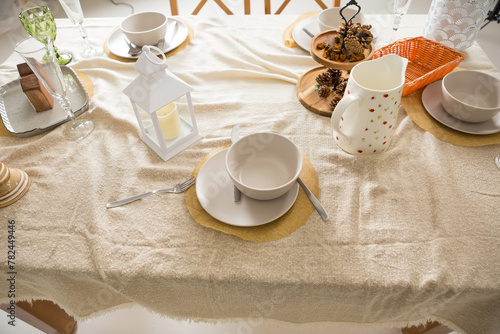 served table with tablecloth and ware