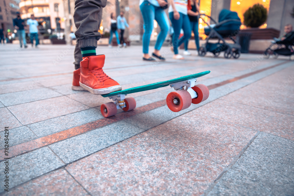 Fototapeta premium Close up of legs of boy skateboarding, sports concept, stock photo