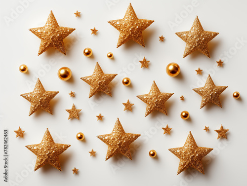 Glittering gold stars and spheres on off-white background