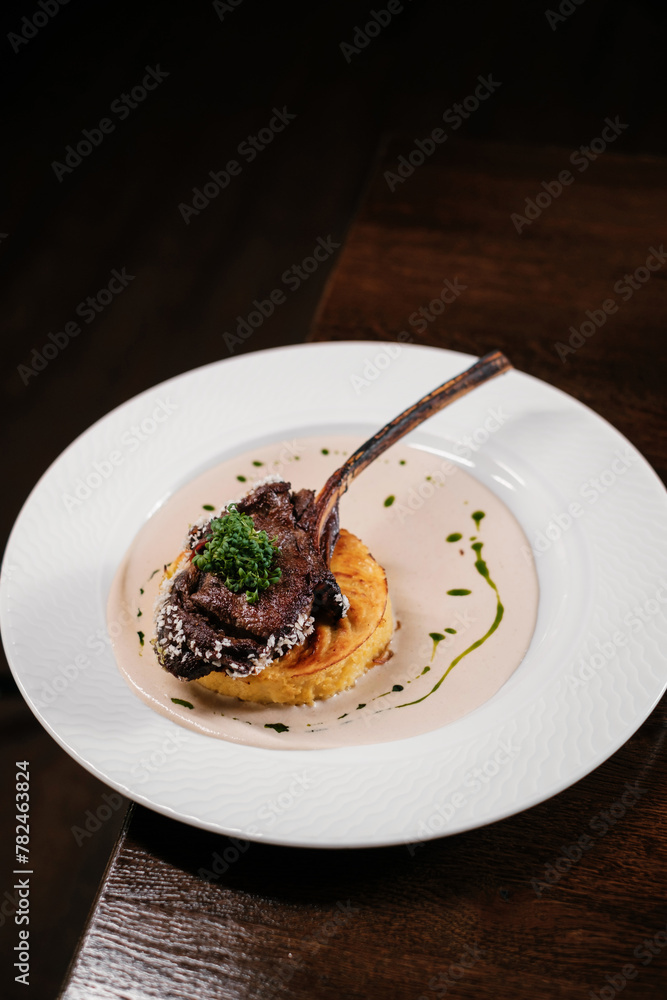 duck leg with sauce on a white plate. dish in a restaurant