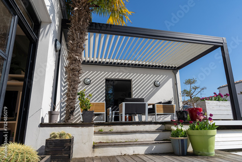 eco friendly bioclimatic aluminum pergola shade structure surrounded by landscaping