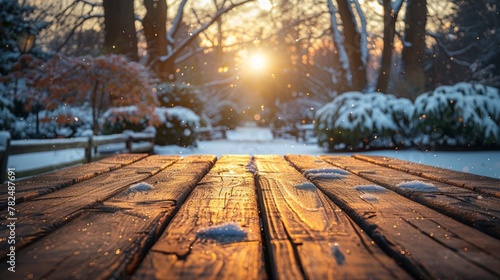 Wooden table in winter park with snow and bokeh lights