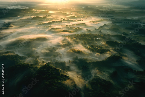 Aerial panoramic view of rural area and forest in foggy sunrise