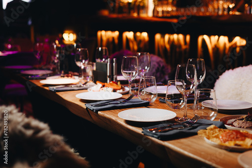 Beautifully organized event - round served table banquet ready for guests  round decorated table with empty plate  glasses  forks  napkin. Elegant dinner table 