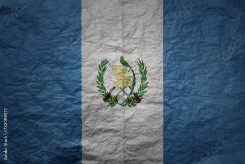big national flag of guatemala on a grunge old paper texture background photo