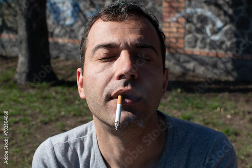 Portrait of a young man smoking cigarette	