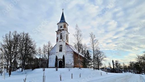 An old small church on snow-covered hill in the Latvian village of Remte in December 2021