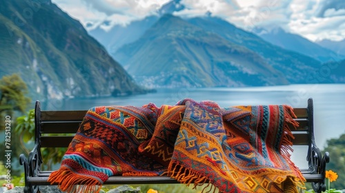 Vibrant handwoven blanket on a bench with majestic mountain backdrop, soft tones, fine details, high resolution, high detail, 32K Ultra HD, copyspace photo