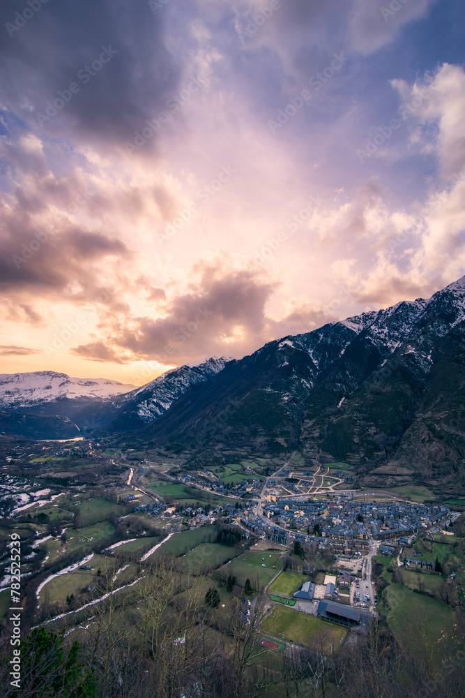View of the village of Benasque at sunset with a spectacular sky. Winter landscape.