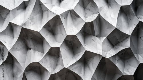 Grayscale image capturing geometric paper folds that play with shadow and light  offering a tactile and visual 3D effect