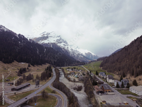 Mountain with snow, on top of a mountain. Forest with the city. Alps