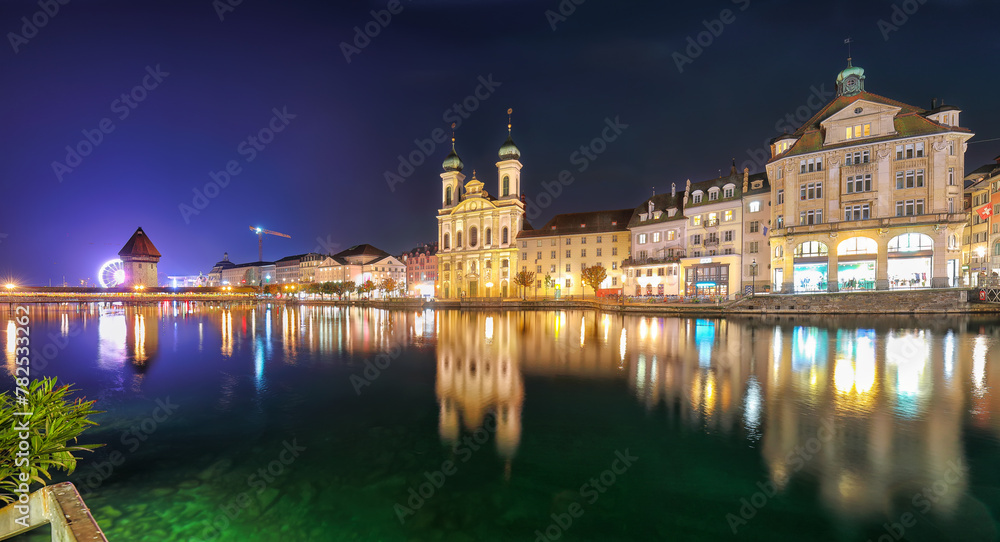 Fabulous historic city center of Lucerne with famous buildings and promenade during night.