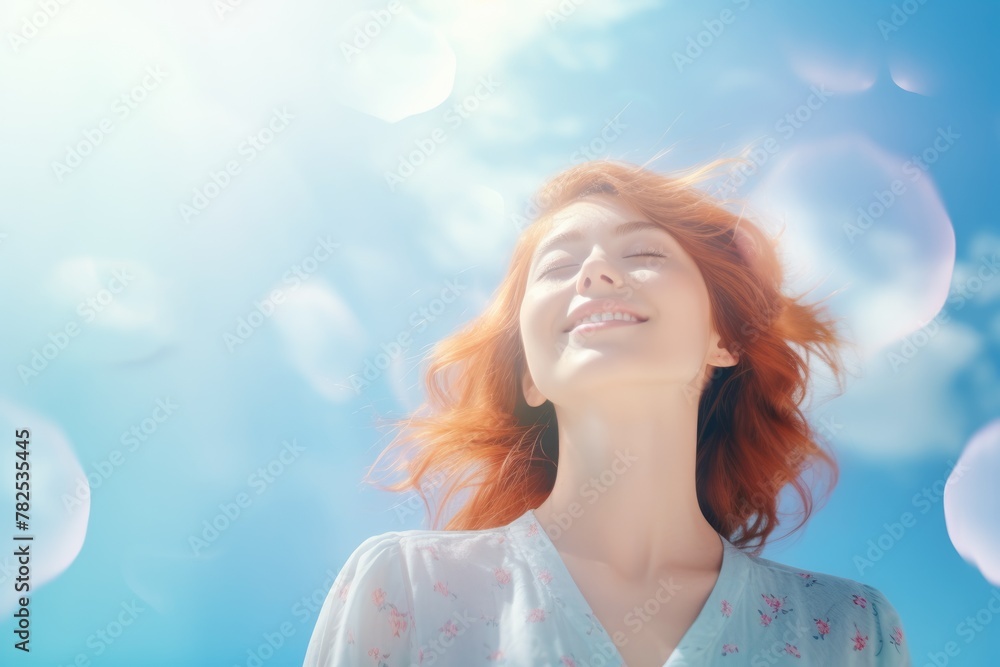 Radiant young redhead woman looking up, basking in sunlight. Radiant young redhead woman looking up, basking in sunlight.