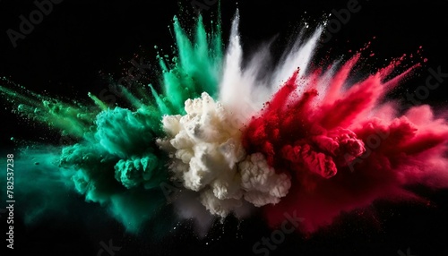 Green, white and red colored powder explosions on black background. Holi paint powder splash in colors of Mexican flag