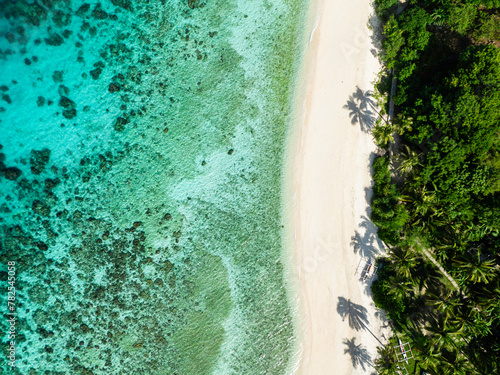 Ocean waves on sandy beach in Cobrador Island. Turquoise sea water in Romblon. Philippines.