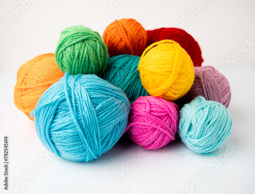 colored balls of wool yarn on a white background