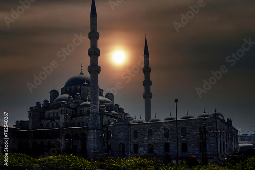 A stunning sunrise illuminates the Yeni Camii Mosque, (New Mosque), a stunning Ottoman imperial mosque located in the Eminönü neighborhood of Istanbul, Turkey photo
