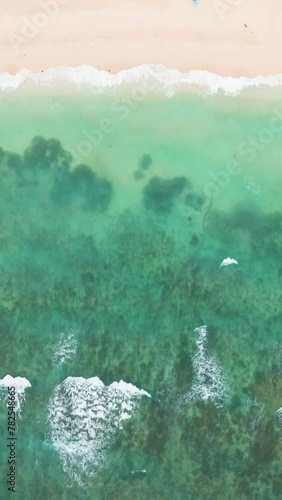 Top view of inshore sea waves on white sand. Ilig Iligan Beach. Boracay, Philippines. Vertical view. photo