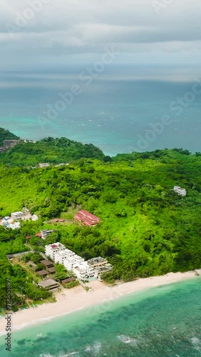 Drone view of beach resorts with ocean waves and white sand. Ilig Iligan Beach. Boracay, Philippines. Vertical view. photo