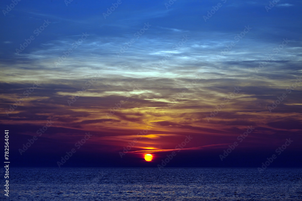 Colorful sunset on the sea. Picturesque seascape with clouds