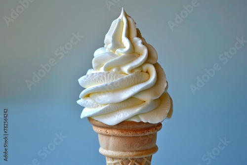 Creamy vanilla ice cream cone against a pastel blue background, photo