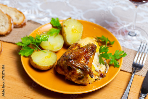 Appetizing fried chicken served on plate with potatoes..