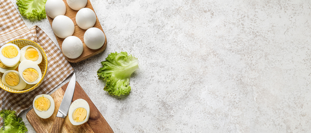 Composition with boiled chicken eggs and lettuce on light background Composition with boiled chicken eggs and lettuce on light background