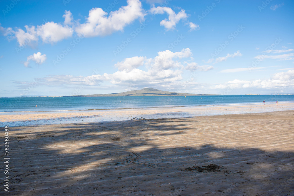 Beach overlooking a volcano located in Takapuna, New Zealand. 