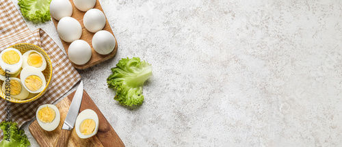 Composition with boiled chicken eggs and lettuce on light background