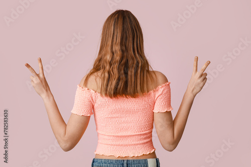 Pretty young woman showing ...