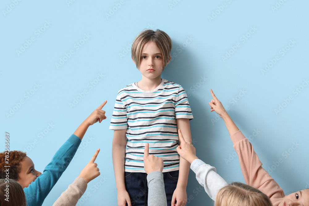 Bullied little boy on blue background - obrazy, fototapety, plakaty 