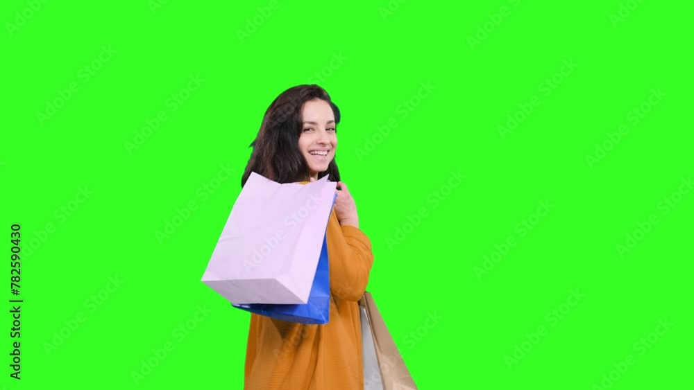 Young attractive woman smiling looking at camera with bags on the chroma key Young attractive woman smiling looking at camera with bags on the chroma key