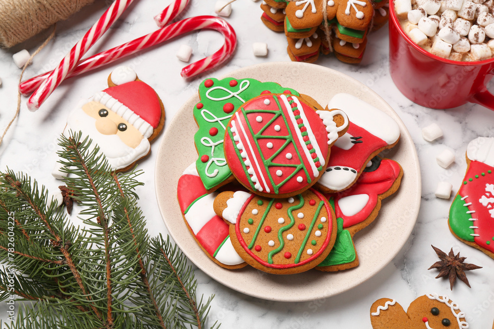 Flat lay composition with decorated Christmas cookies on white marble table