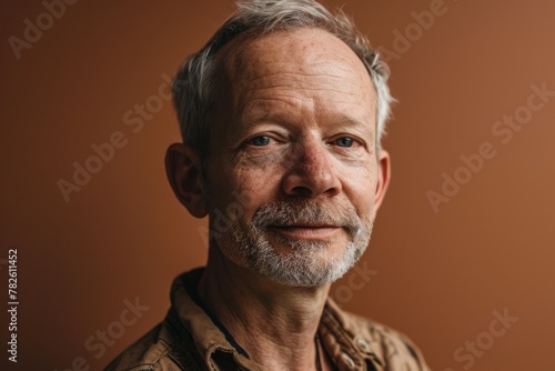 Portrait of a senior man with grey hair and a beard.