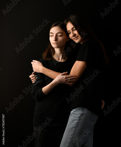 beautiful portrait of a couple of girls on a black background