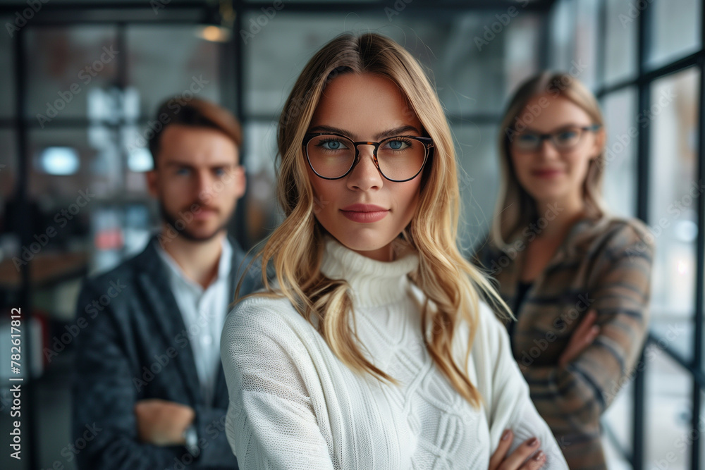 Three people are standing in front of a window, with one woman wearing glasses Three people are standing in front of a window, with one woman wearing glasses