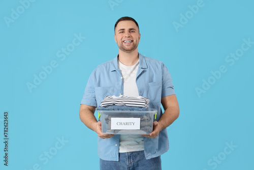 Young man holding box with ...