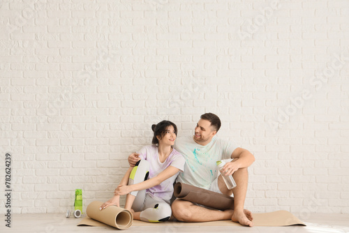 Sporty young couple sitting...