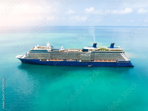 Aerial view of beautiful white cruise ship above luxury cruise. Cruise ship sailing across The Mediterranean sea - Aerial footage. 