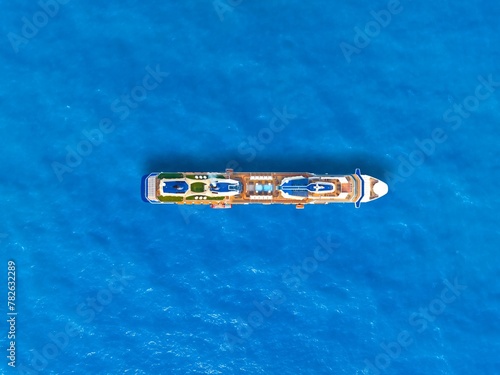 Aerial view of beautiful white cruise ship above luxury cruise. Cruise ship sailing across The Mediterranean sea - Aerial footage. 