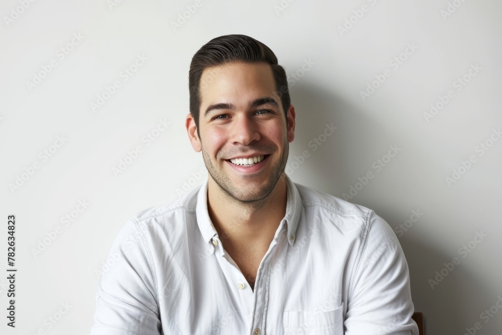 Portrait of a handsome young man smiling against a white background. Portrait of a handsome young man smiling against a white background.
