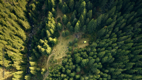 Aerial sun mountain top down. Pine trees forest. Nobody nature landscape at summer day. Mount ridges with green plants. to Carpathians  Ukraine  Europe. Travel  tourism concept. Cinematic drone shot