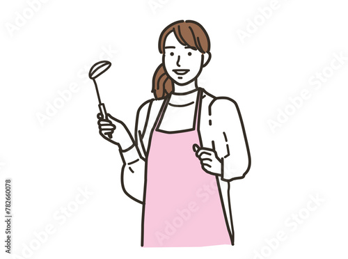 キッチンで料理をするエプロン姿の女性
